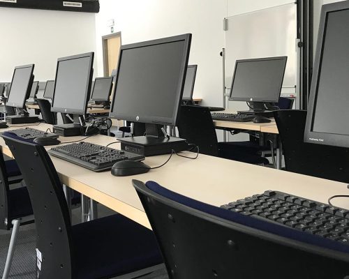 Lecture room 022 with computers on the tables